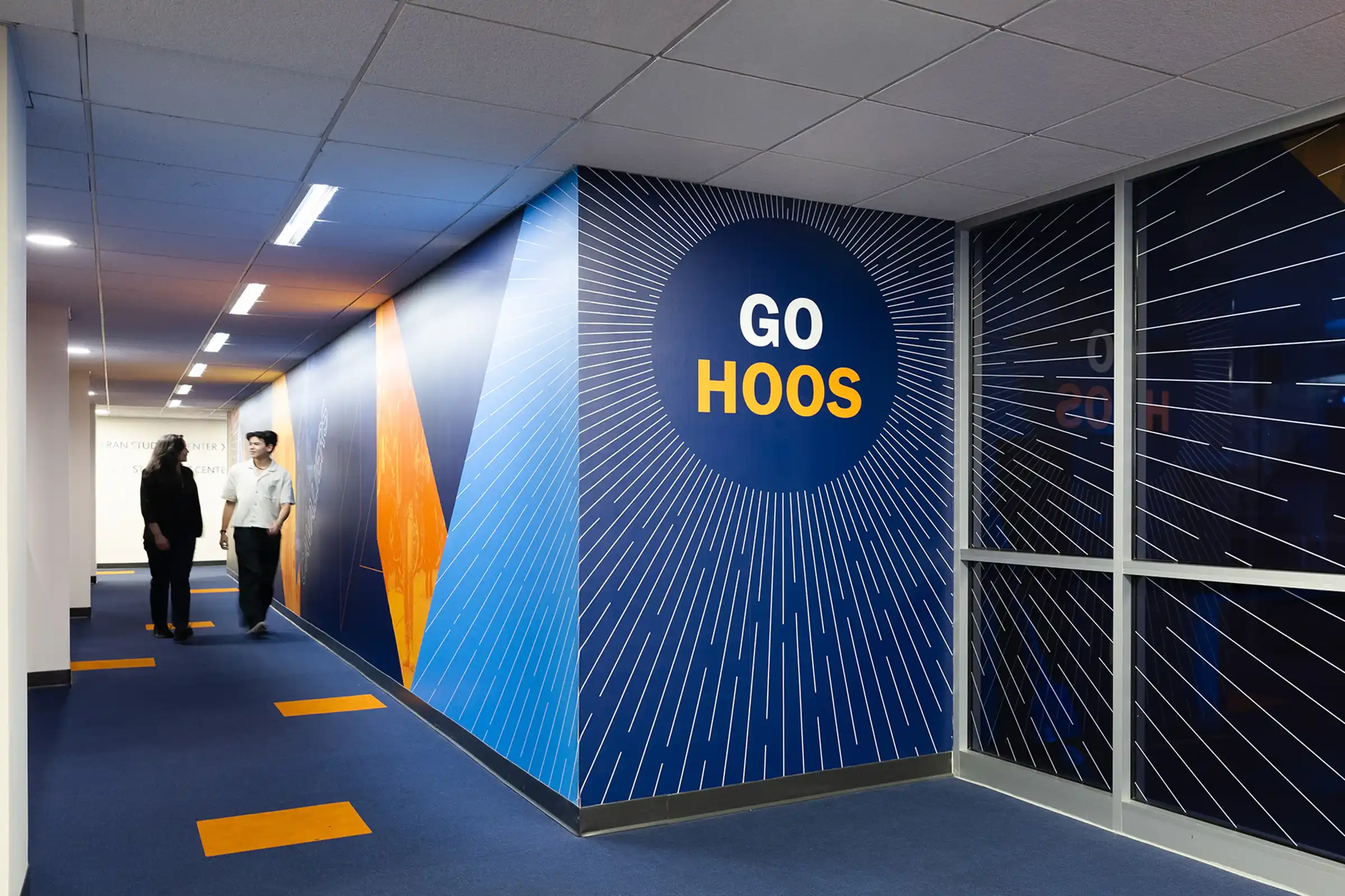 "Go hoos" wall graphics in a hallway at Newcomb Hall