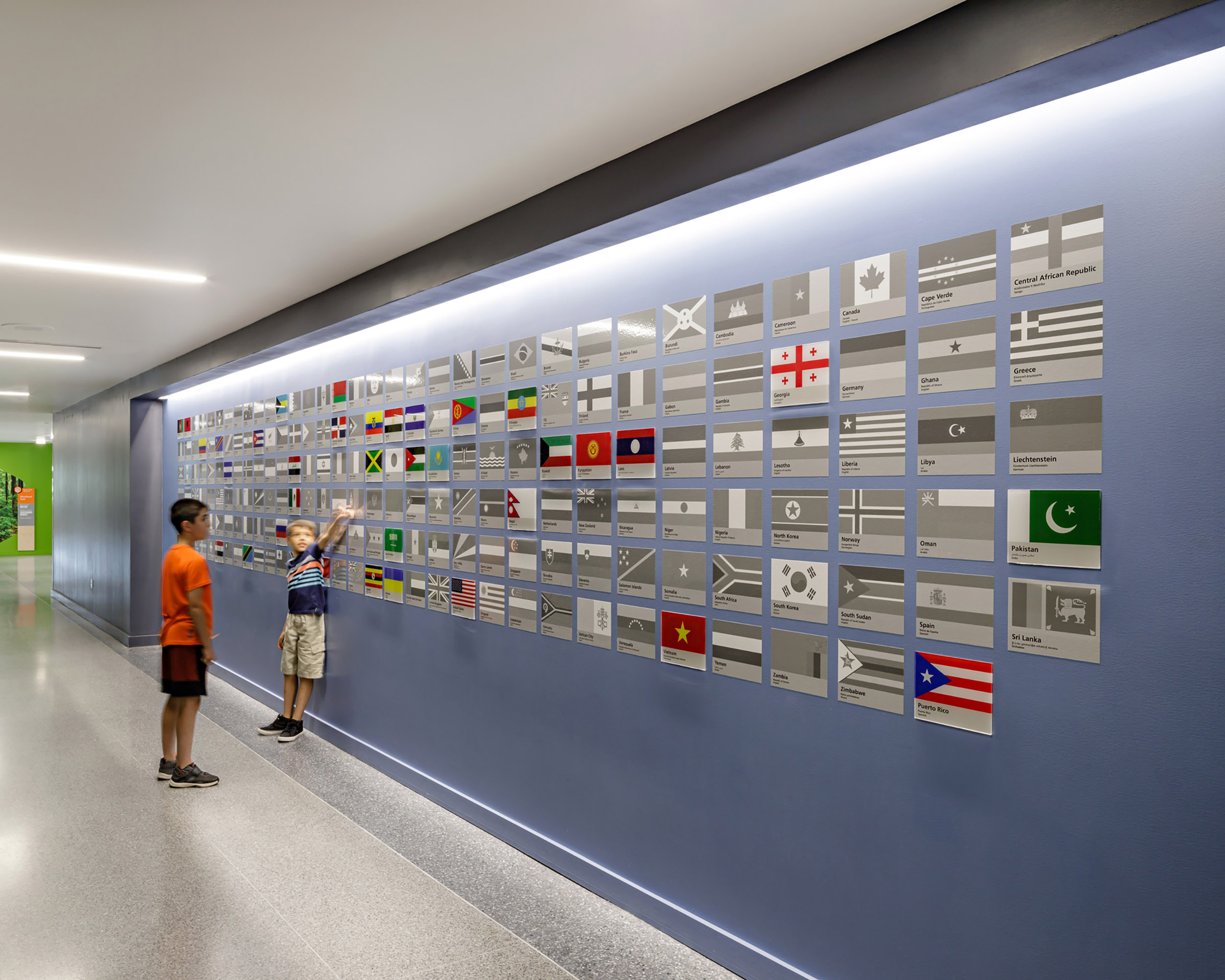 Children interact with a wall of flags at Bluestone Elementary School
