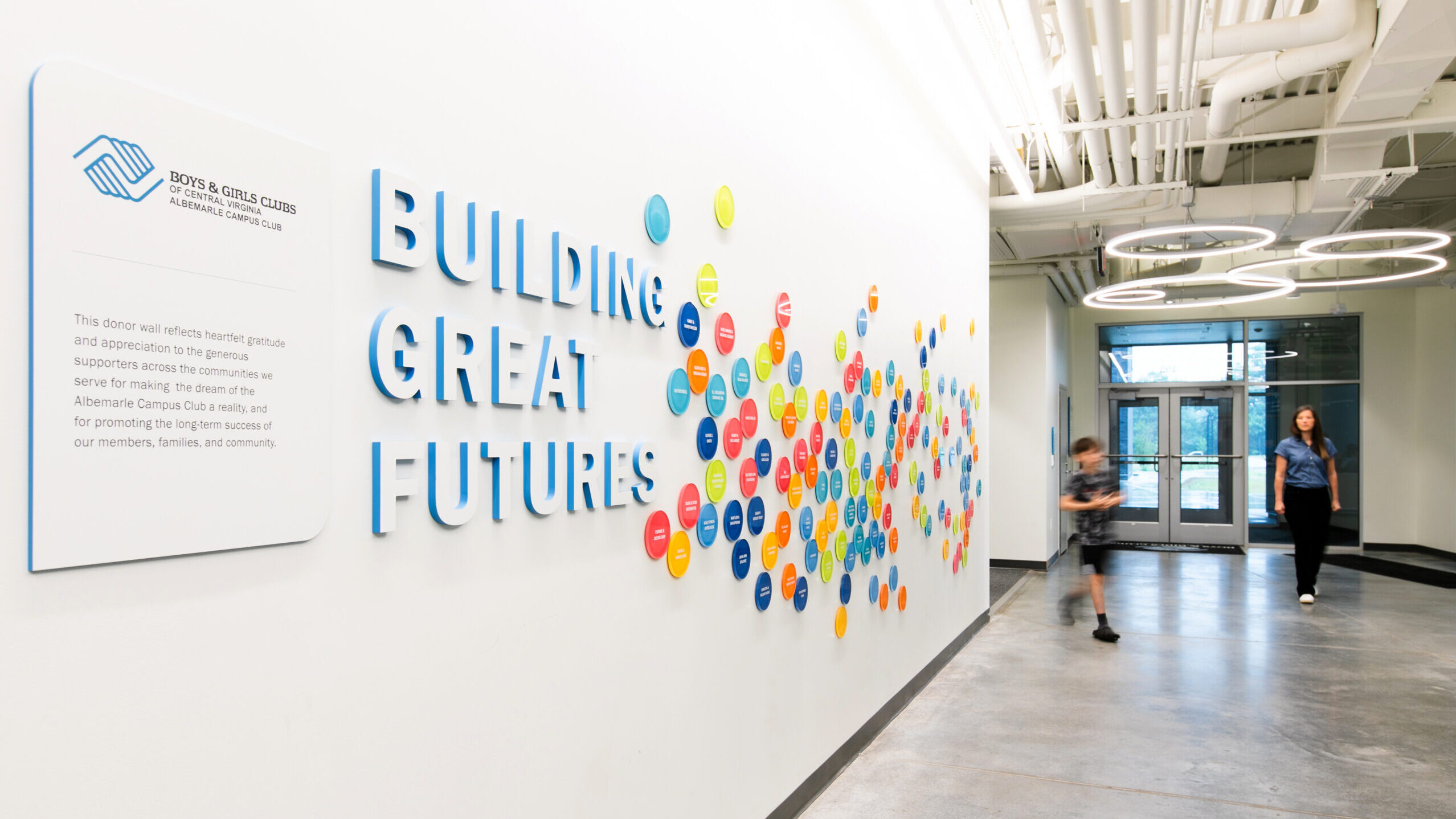 Colorful donor signage on a wall at the Boys & Girls Club’s Albemarle Campus with text that says "Building great futures".