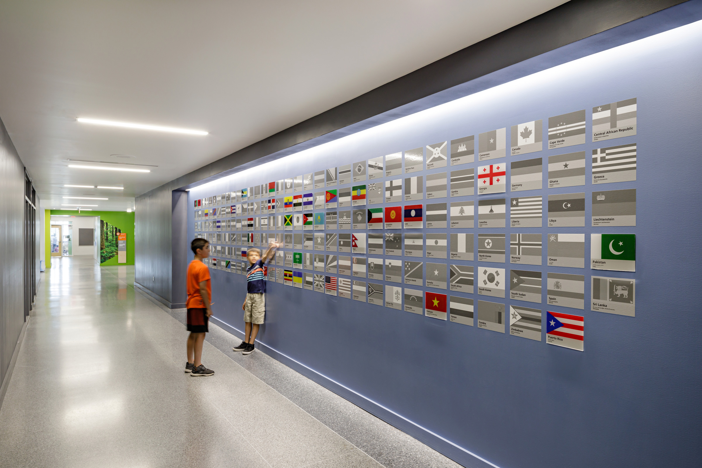Children interact with a wall of flags at Bluestone Elementary School
