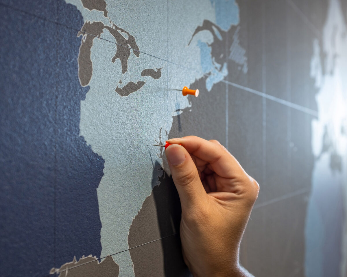 A hand places a pin on a map at Bluestone Elementary School