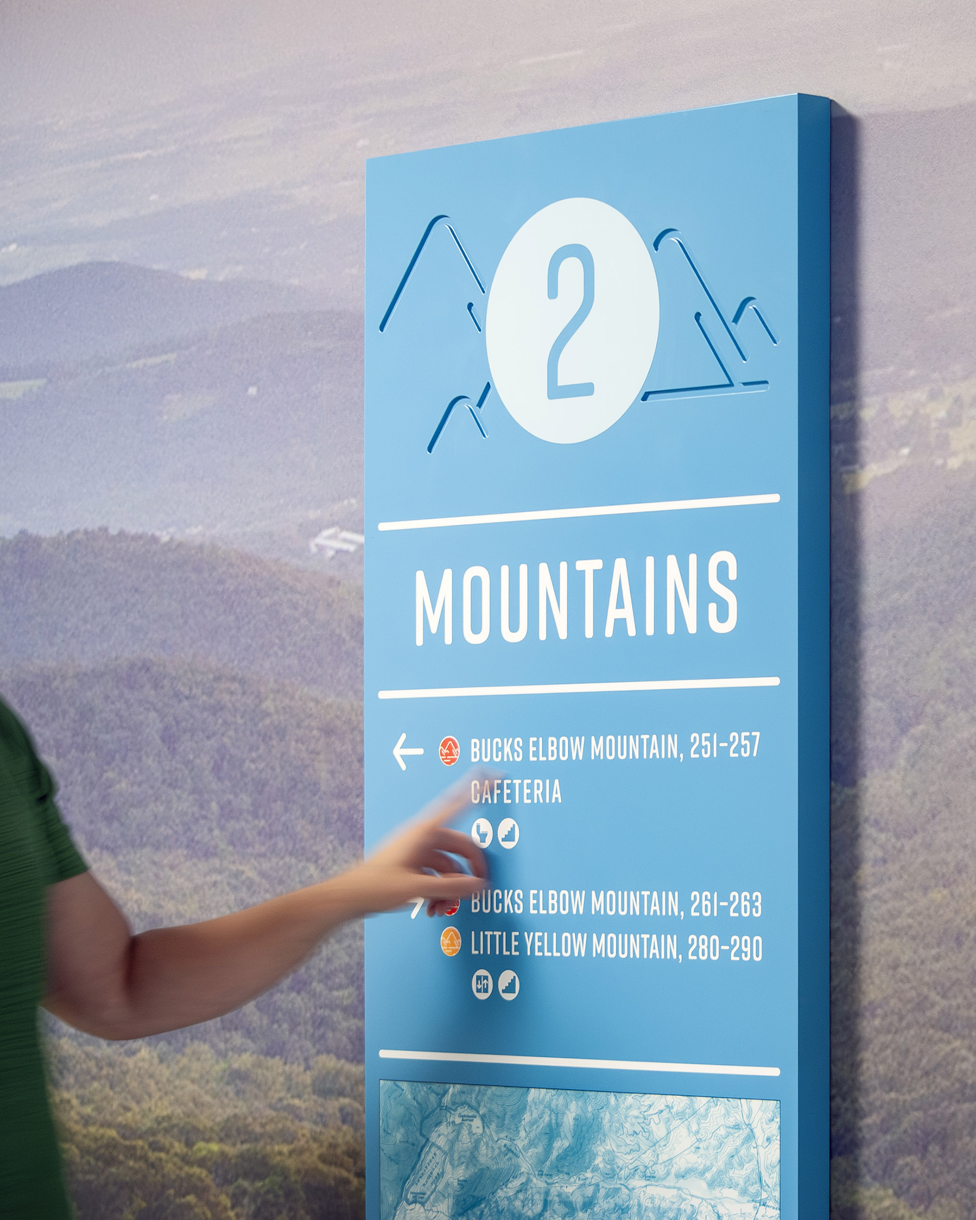 A person interacts with a textured wayfinding sign at Crozet Elementary School