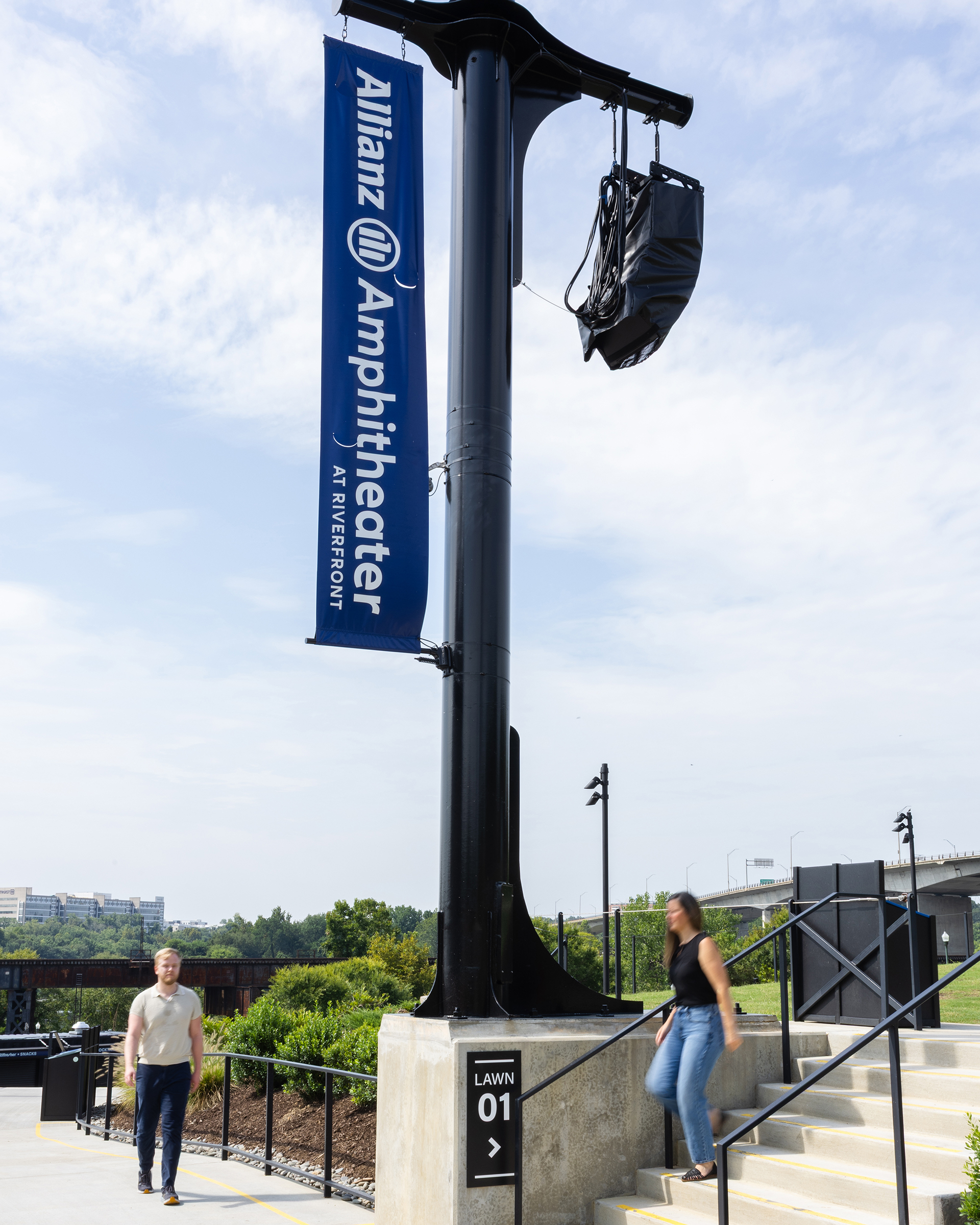 People walking below an Allianz Amphitheater banner