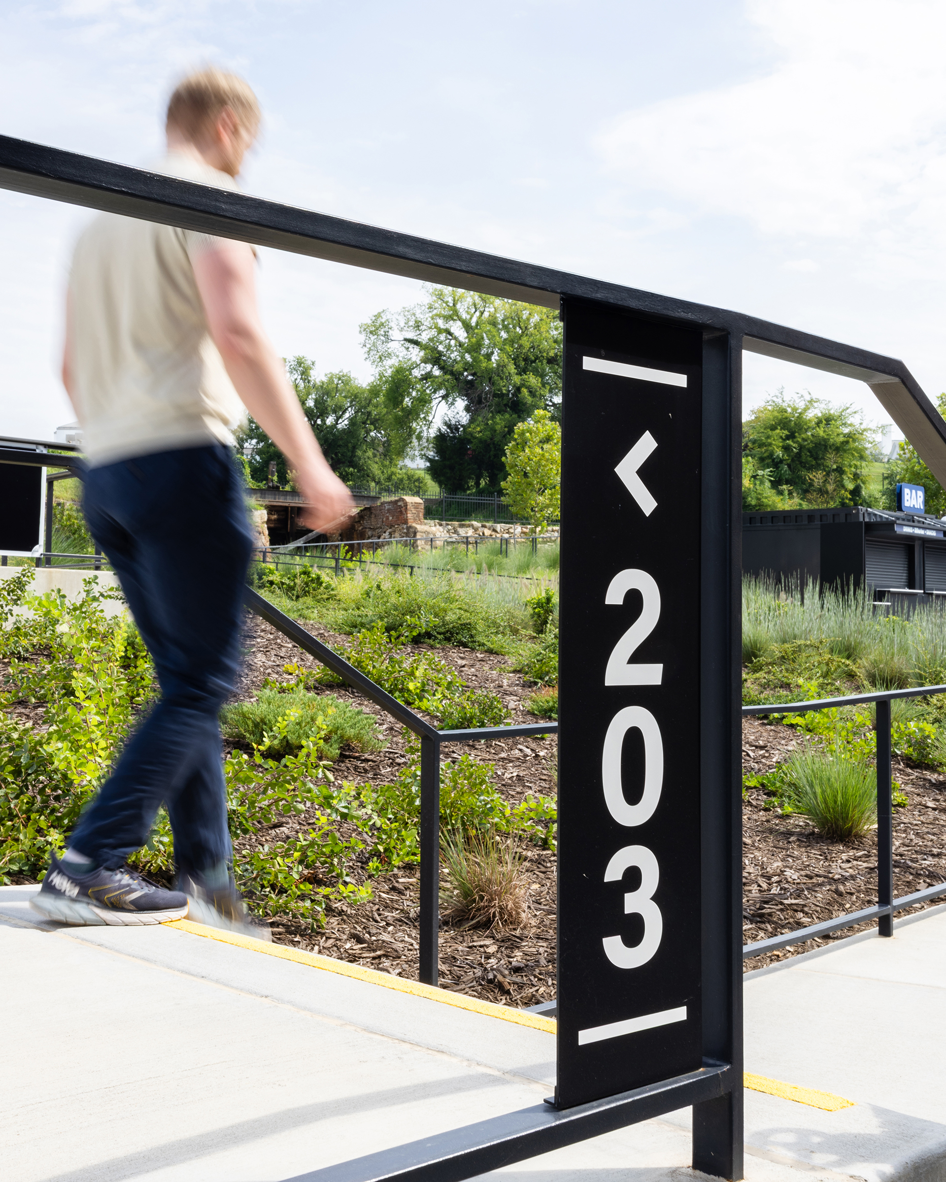 A man walks by a seat number directional sign at Allianz Amphitheater