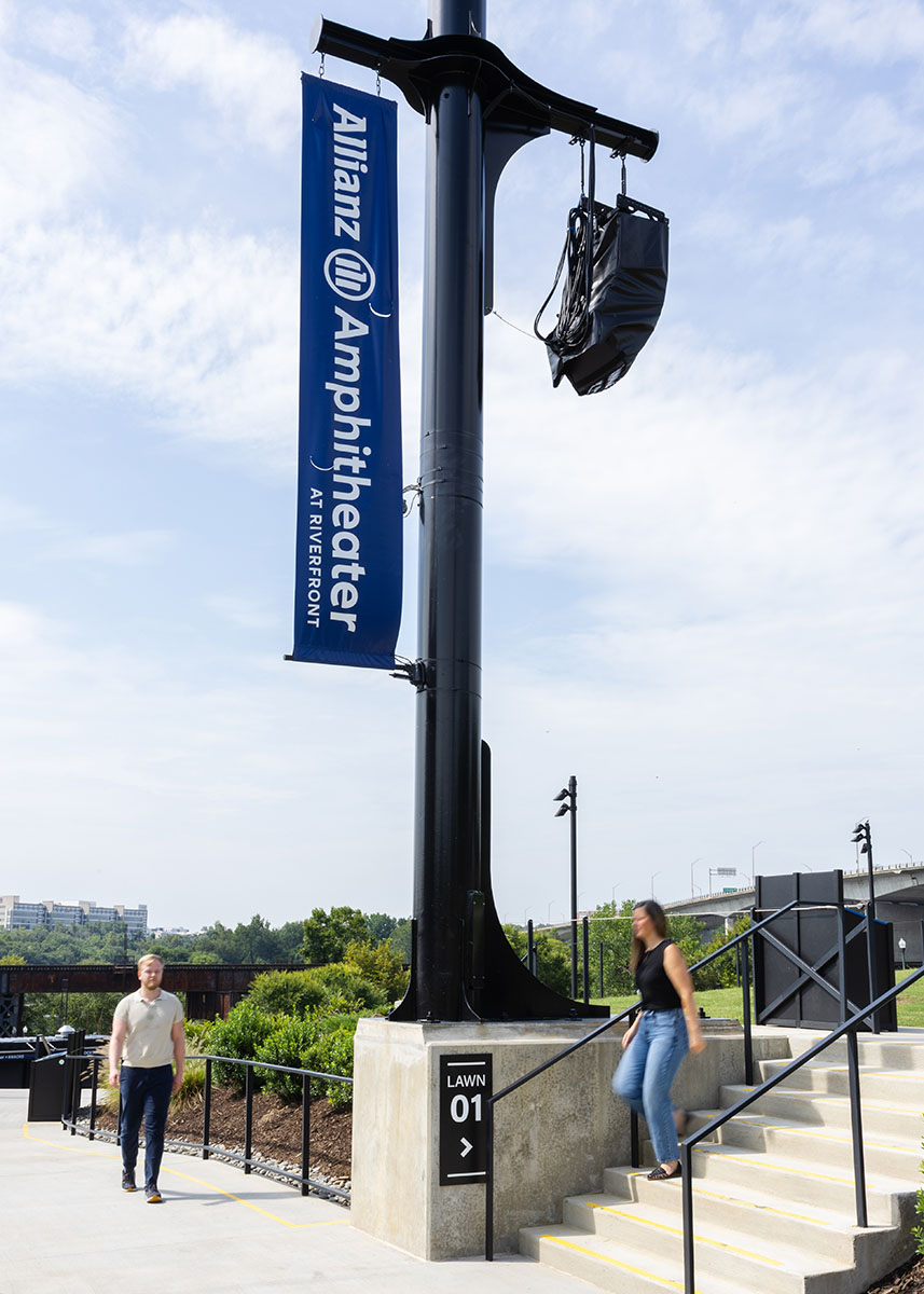 People walking below an Allianz Amphitheater banner