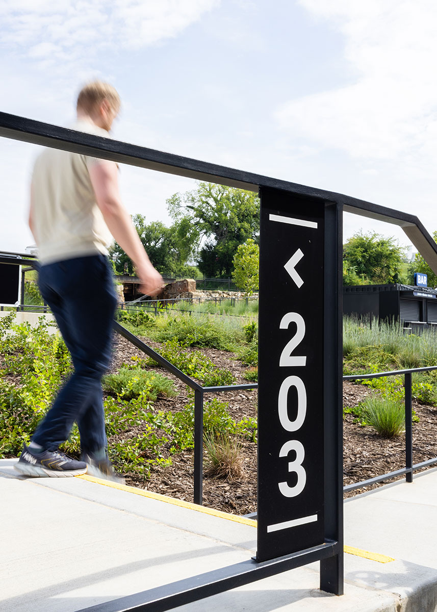 A man walks by a seat number directional sign at Allianz Amphitheater
