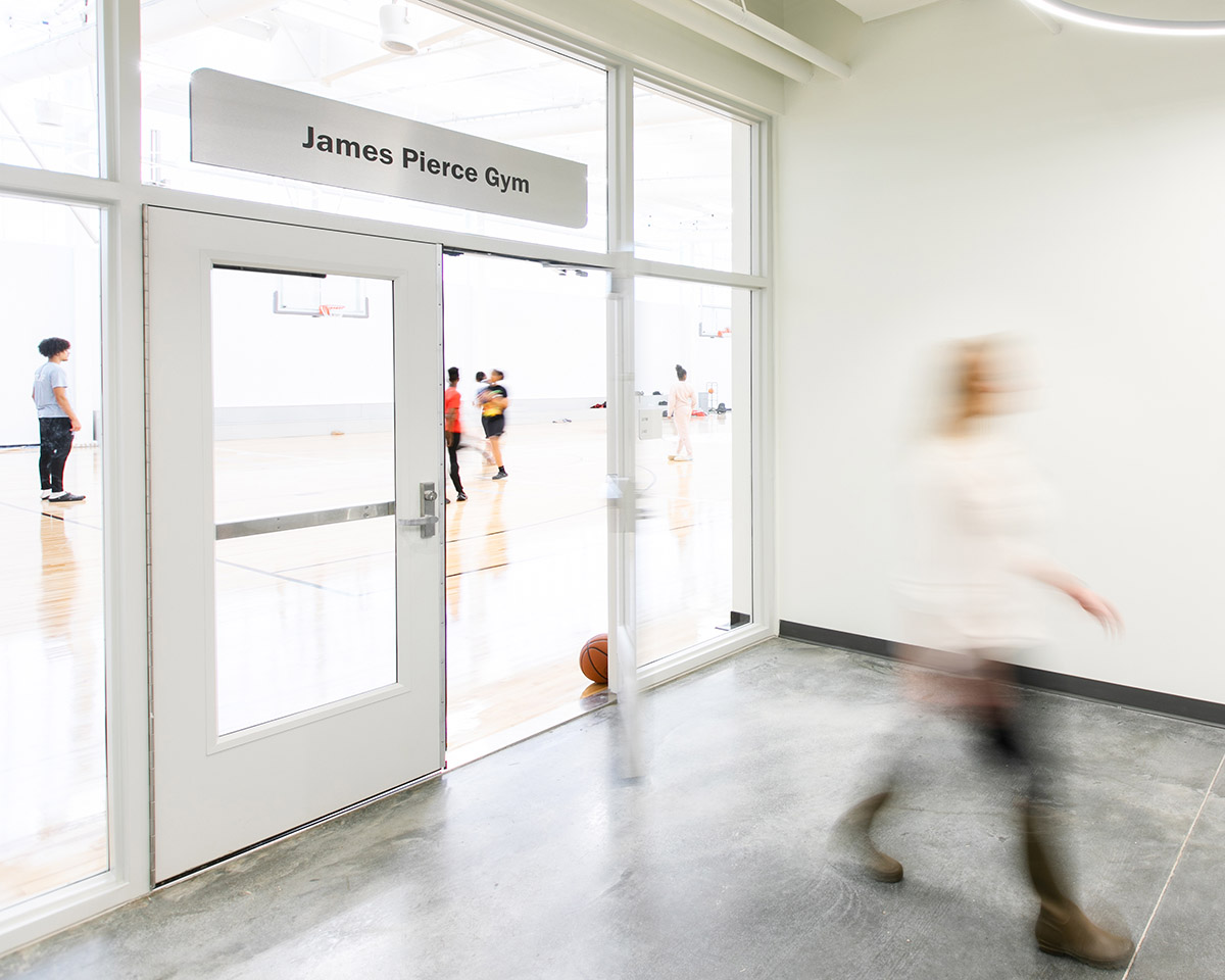 Destination Identification Signage on glass above a door at the Boys & Girls Club’s Albemarle Campus