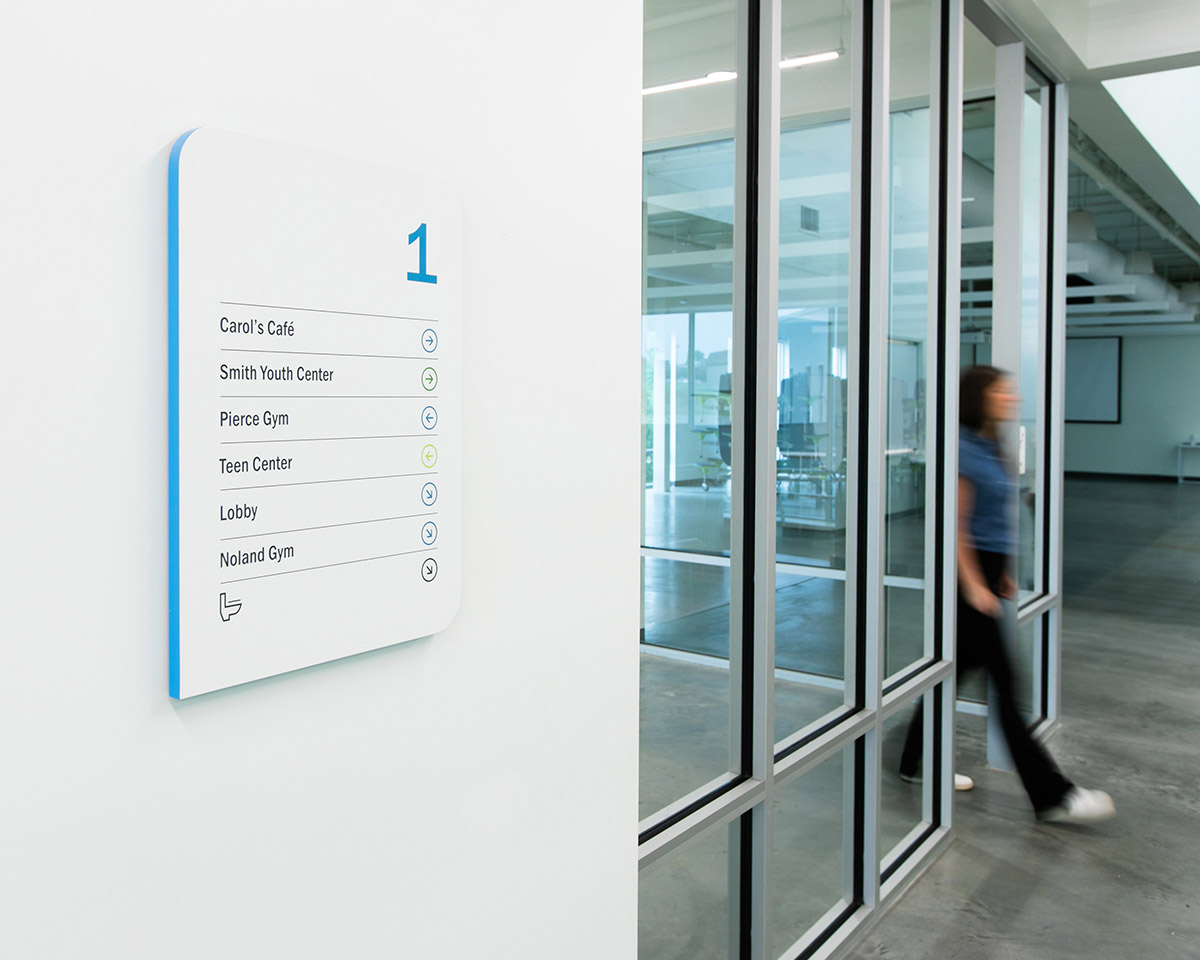 Wayfinding signage on a wall at the Boys & Girls Club’s Albemarle Campus