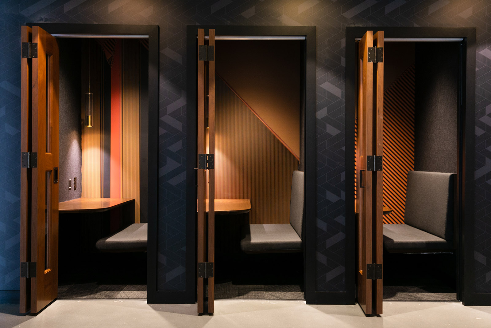 Individual work booths at CODE with logo wall graphics