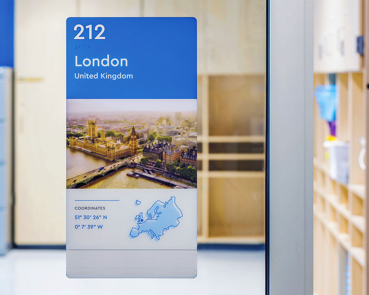 Classroom number 212 sign at Cardinal Elementary School featuring a photo and coordinates of London UK