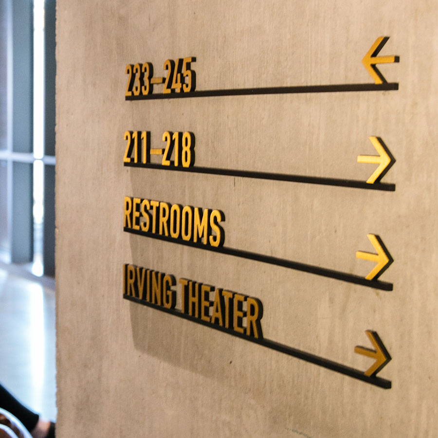 Metal wayfinding signage at CODE