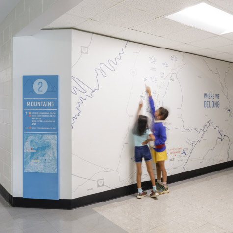 Children interact with a map graphic on the wall at Crozet Elementary School