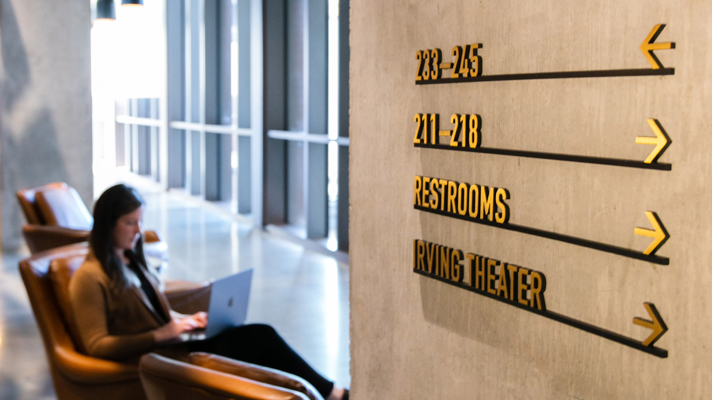 Metal wayfinding signage at CODE