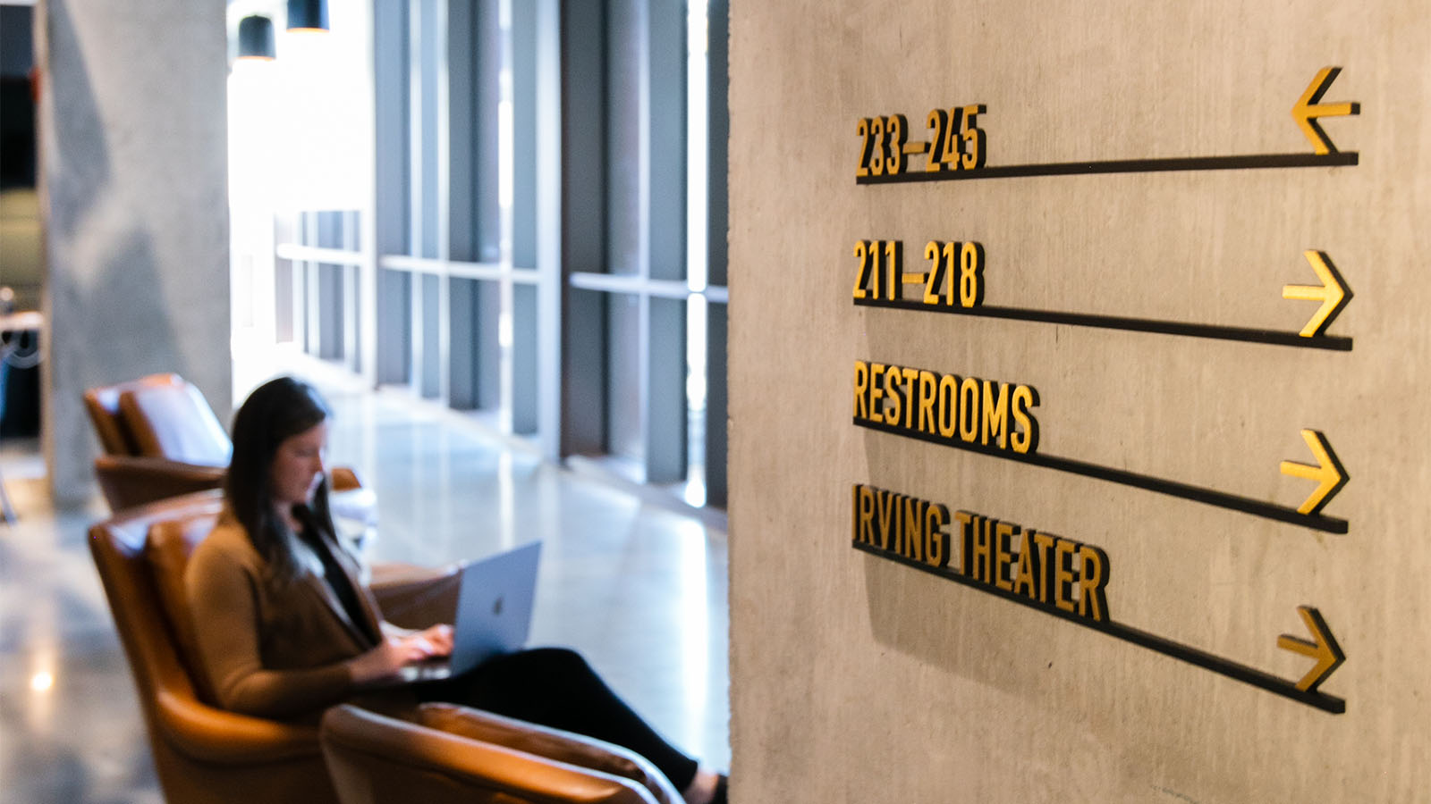 Metal wayfinding signage at CODE