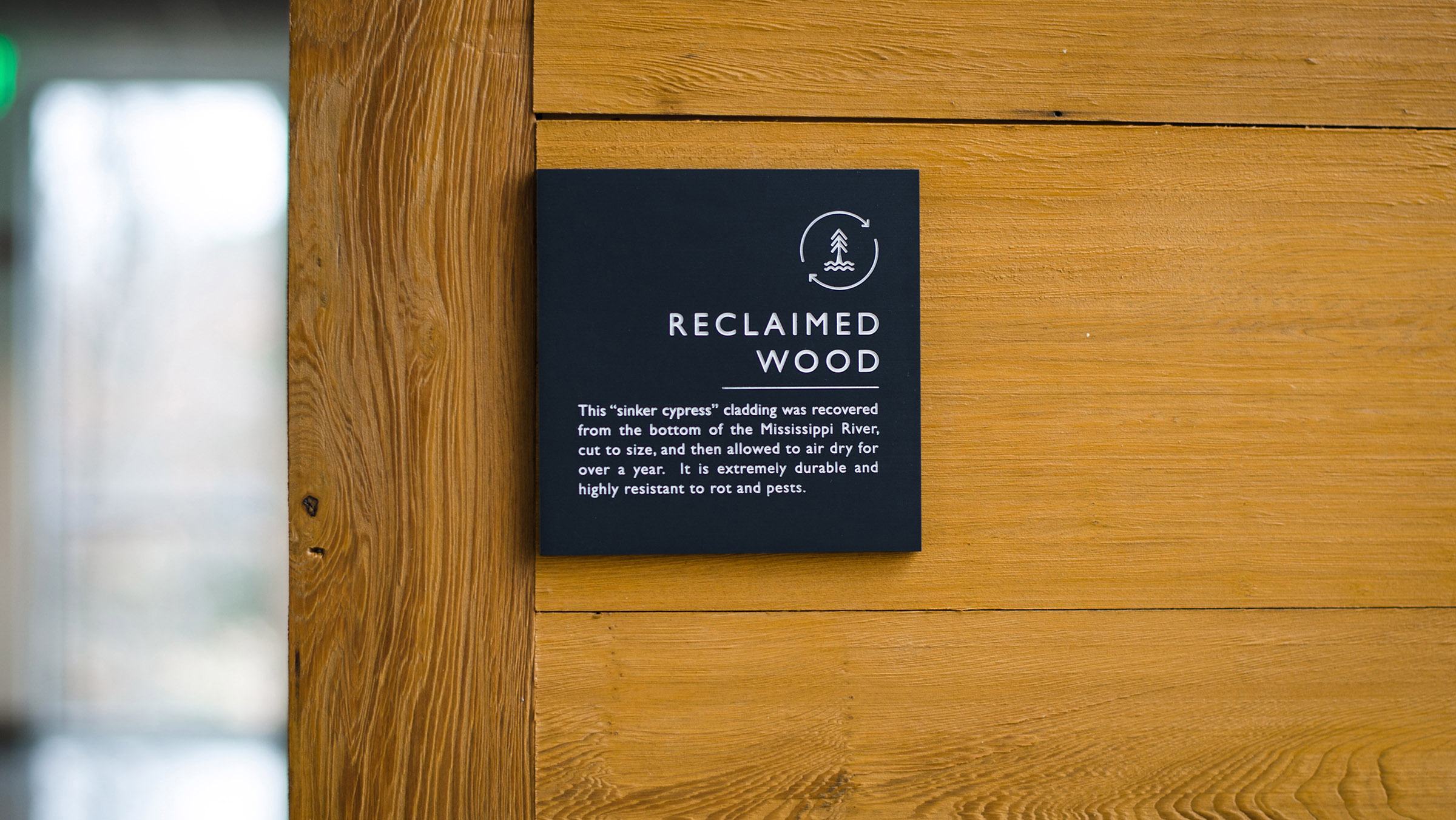 Informational sign at Greer Environmental Sciences Center about the reclaimed wood used for the walls