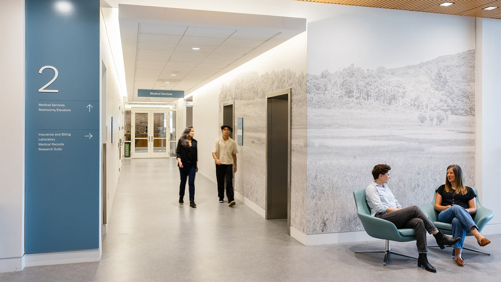 Second floor directional signs and wall graphics at Student Health & Wellness Center