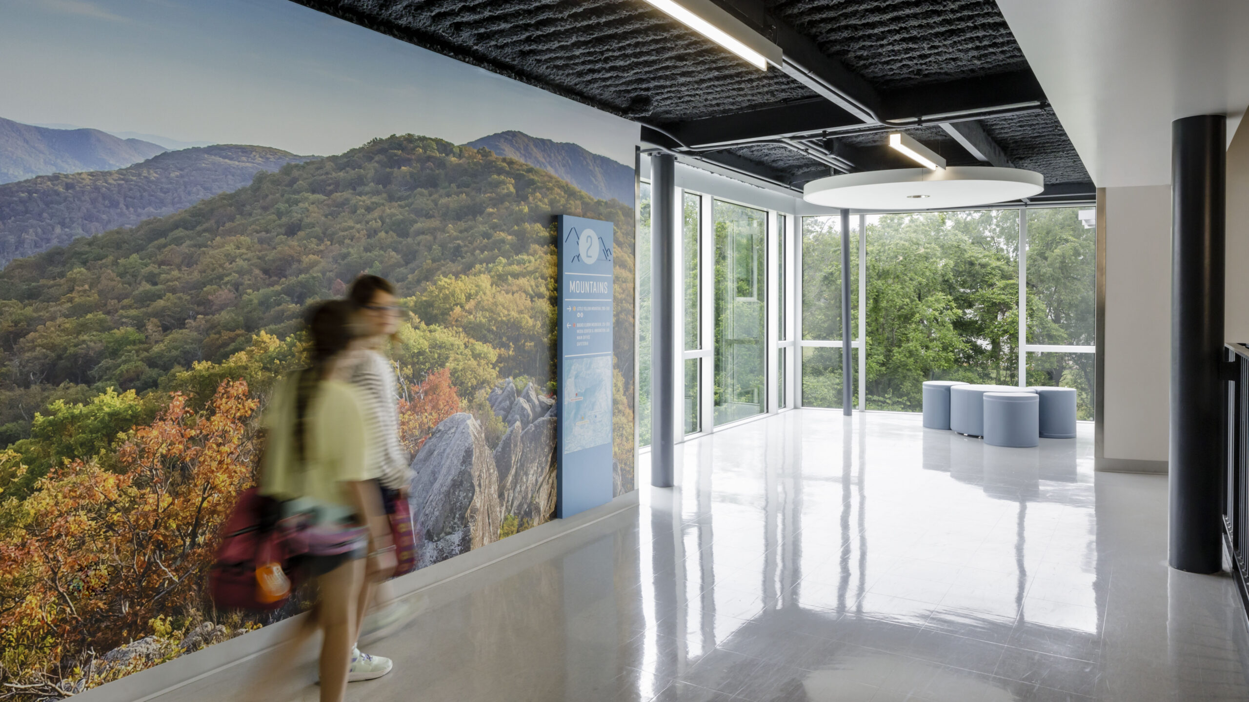 People walking by wall graphics of the blue ridge mountains at Crozet Elementary School