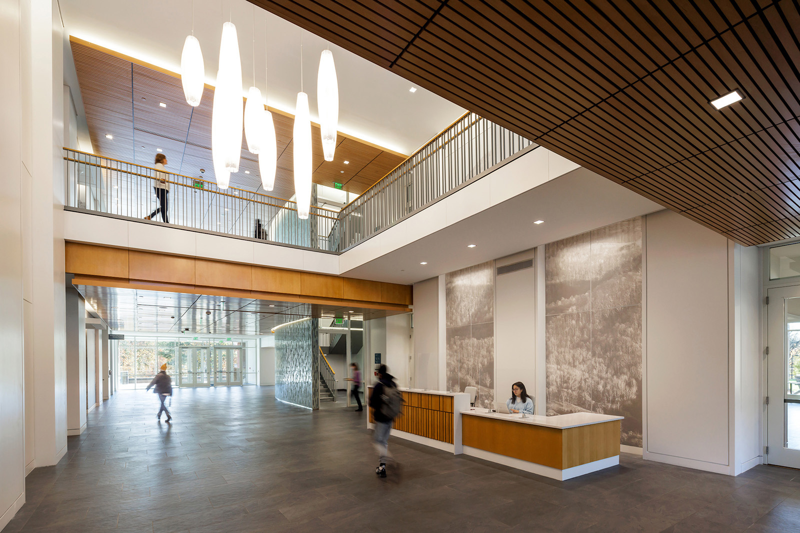 View from the entrance of Student Health & Wellness Center Lobby featuring wall graphics behind the welcome desk.