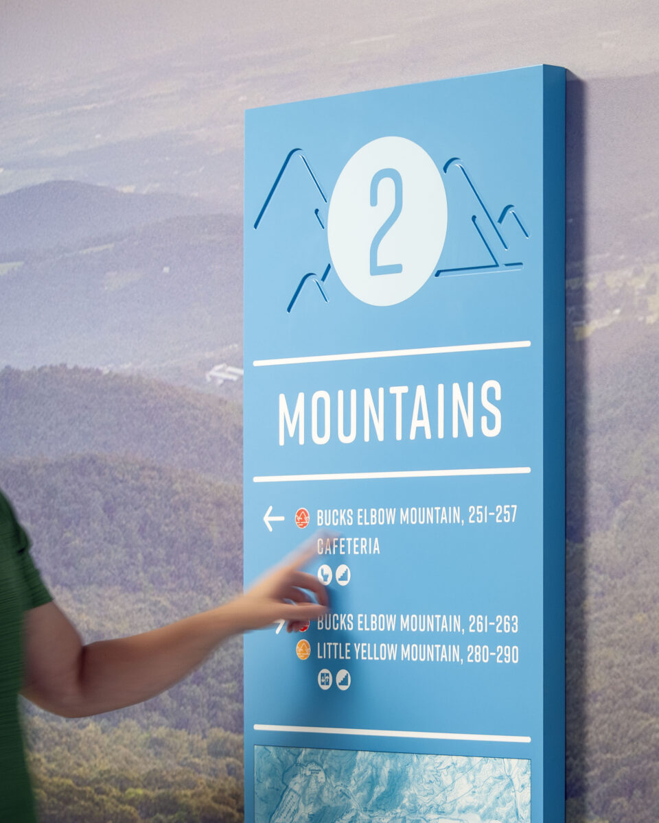A person interacts with a textured wayfinding sign at Crozet Elementary School